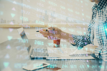 Multi exposure of stock market chart with man working on computer on background. Concept of...