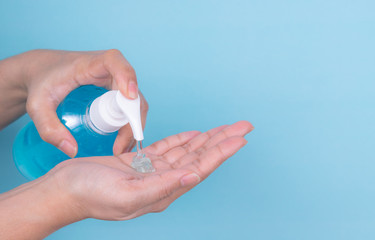 Close up woman hand take cleaner  from alcohol sanitizer bottle. Protective coronavirus or covid-19 outbreak  concept.