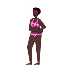 Black woman in pink swimsuit standing in confident pose