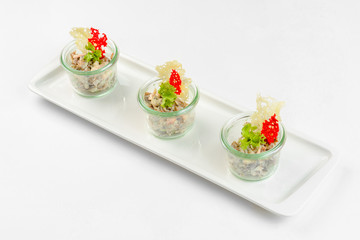 Appetizer vegetable salad in glass on white background. Catering service