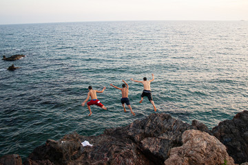 children jumping into the water from cliff