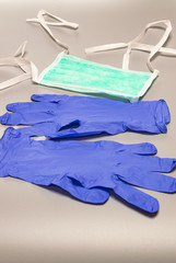 Health,safety and protective concept: Medical mask and gloves on gray background, protection against viruses and bacteria.