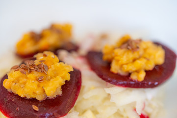 delicious salad on a white plate  with kohlrabi, beetroot, lentils and grains