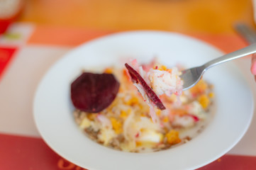 delicious salad on a fork with  kohlrabi, beetroot, lentils and cereals