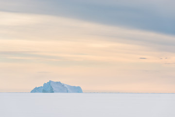 Iceberg on frozen sea, Greenland