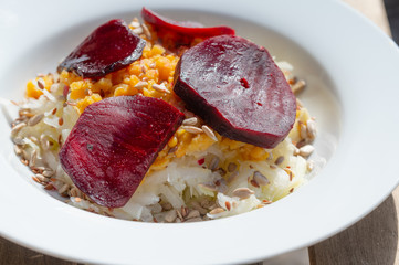 delicious salad on a white plate  with kohlrabi, beetroot, lentils and grains
