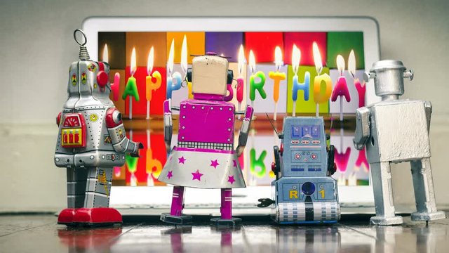 four robots watching HAPPY BIRTHDAY candles burning  cinemagraph