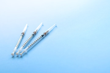 Medical Syringes on patchy light blue Background, Close up Syringe, Health care concept.