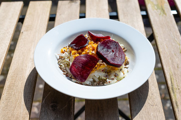 delicious salad on a white plate  with kohlrabi, beetroot, lentils and grains