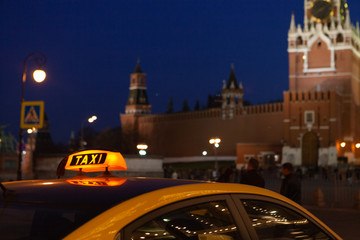 The big taxi sign on the background of night city. Moscow taxi.