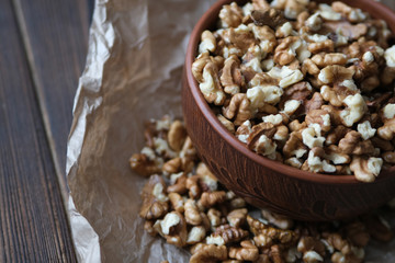 Walnuts on dark wooden background