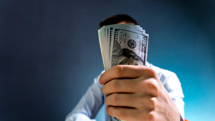 doctor holds dollars in his hand