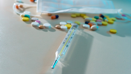 medical mask and pills on the table