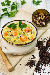 Homemade Fresh Creamy Soup with Chicken, Carrot, Vegetables and Wild Rice. Selective focus.