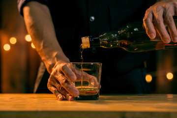 Bartender Serve Whiskey, on wood bar..