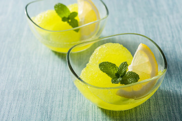 Lemon sorbet in glasses on blue background