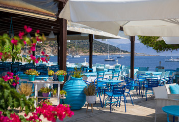 Traditional blue and white greek tavern with magnificent sea view on a summer sunny day in Kastos...