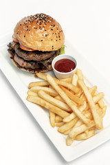 beef burger with french fries platter on white table