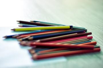 Fototapeta premium Assortment of colored pencils, Colored Drawing Pencils, Colored drawing pencils in a variety of colors laying on floor in back light. Drawing like good idea for quarantine in school