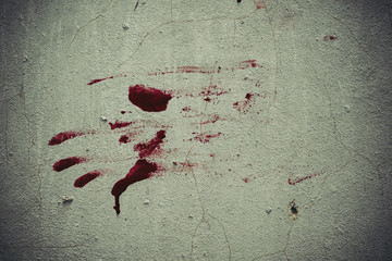 Red blood like hand shape stuck on the grunge wall background in abandoned house. Halloween haunted...