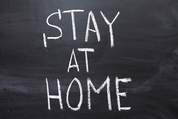 Obraz premium Coronavirus pandemic behaviour rules or health advice - stay at home. Stay at Home. Stay at Home chalkboard inscription