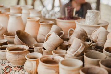 Fototapeta na wymiar Handmade clay brown pots on a blurred background