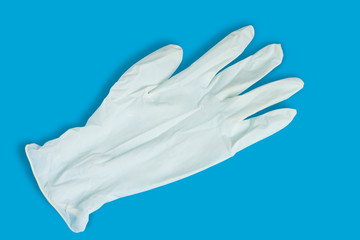 Fototapeta na wymiar Light medical hygiene glove on a blue background