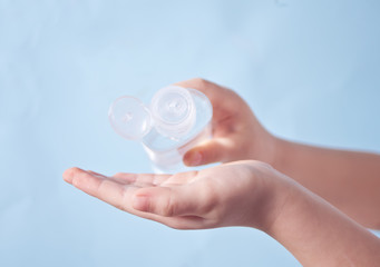 Child using a hand sanitizer. Antibacterial antiseptic. Prevent the virus and bacterias, hygiene and Covid-19 virus protection concept.