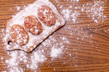 Cutlets lie on the board. View from above