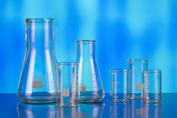 Empty laboratory test tubes as a symbol of medical tests on the metal table and blue background