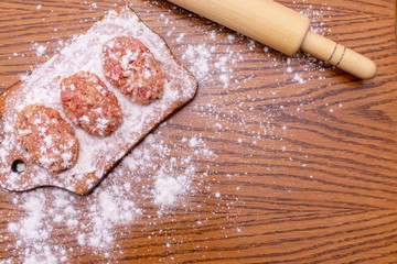 Cutlets lie on the board. View from above