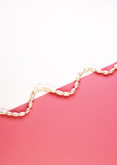 women's jewelry made of pearls. white beaded bracelet on a pink background. pastel background for women's day