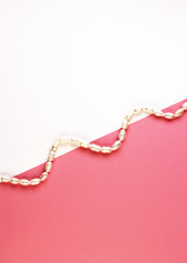 women's jewelry made of pearls. white beaded bracelet on a pink background. pastel background for...