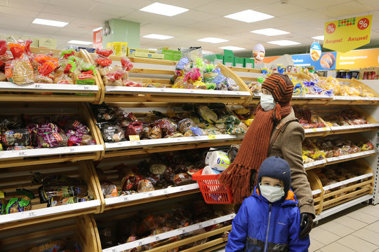 Covid-19, coronavirus in Moscow city, Russia. Shoppers in russian store with buckwheat, toilet paper. Products on empty shelves. Medical mask. Covid-19 economic crisis. Retail