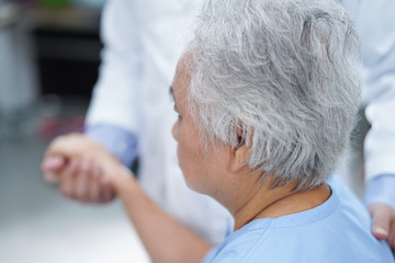 Holding Touching hands Asian senior or elderly old lady woman patient with love, care, helping, encourage and empathy at nursing hospital ward : healthy strong medical concept