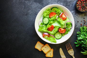 Healthy salad, leaves mix salad (mix micro greens, cucumber, tomato, onion, other ingredients). food background. copy space for text