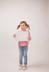 On white background with copy space. the girl is holding a white paper