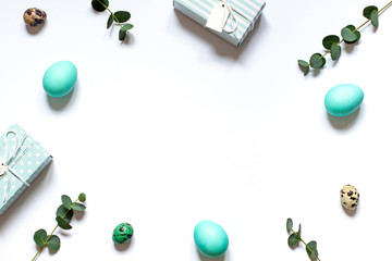 Easter celebration concept frame on the white background with gifts and painted eggs. Copy space