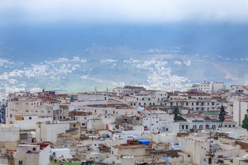 Fototapeta na wymiar View of the Tetouan Medina quarter in Northern Morocco with old buildings roofs.
