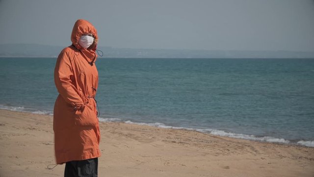 Lonely girl on the beach during coronavirus quarantine in Greece
