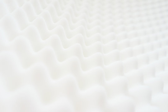 White gradient abstract background with many waves at different angles.
