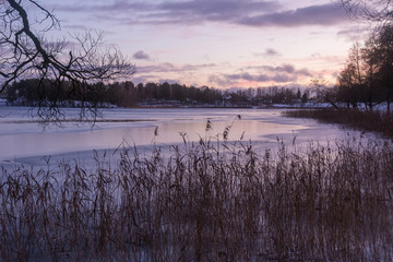 Beautiful winter landscape with lake in evening time.