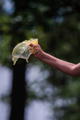 Hand with drinking water pours water. The conditions of the water and environmental crisis