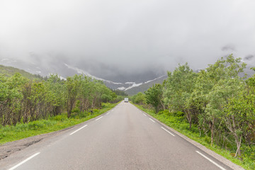 road passing in a valley between mountains in Norway, selective focus
