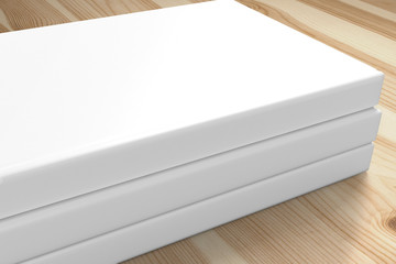 3 book with blank white hardcover on wooden desk background as template for your design presentation, promotion etc.