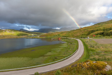 Colorful Rainbow over the road to Unstad in Lofoten islands, Norway