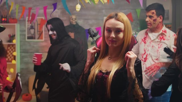 Sexy blonde in enchantress costume at halloween party