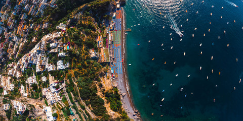 Beautiful top down aerial panorama view of Amalfi coast. Rocky shores and incredible beaches, Luxury yachts, boats and apartments overlooking Tyrrhenian Sea. Bright sunny day. Positano, Italy © Sergey