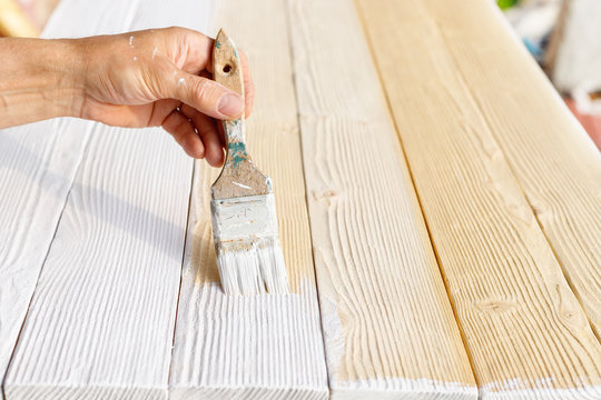 Worker Painting White Wooden Furniture Outdoor.