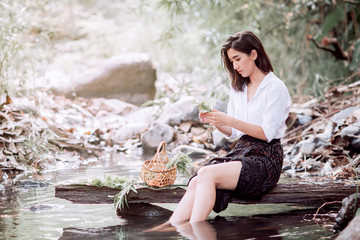 Woman in folk costume Washing vegetables for cooking